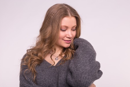 Fashion, style and people concept - portrait of a beautiful young woman with a gentle smile over white backgroundの写真素材