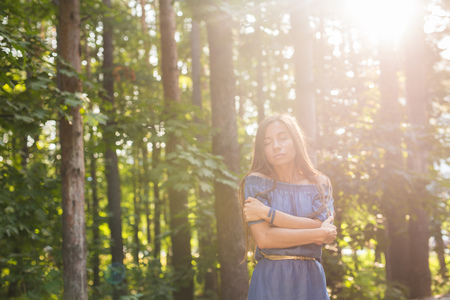Nature, summer and people concept - Portrait of romantic young woman in forestの写真素材