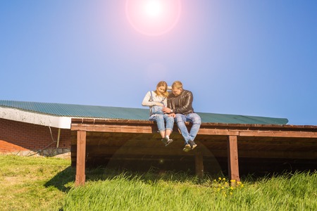 Family, pregnancy and people concept - Pregnant woman with husband in natureの写真素材