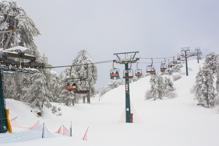 January 1, 2017. Cyprus. Ski lifts and cable cars going up the mountain bringing snowboarders to ski slopes.のeditorial素材