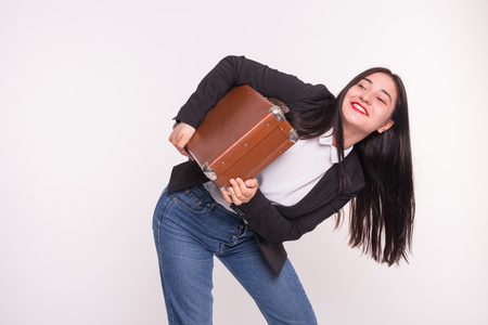 Young asian woman holding leather suitcase on white backgroundの写真素材