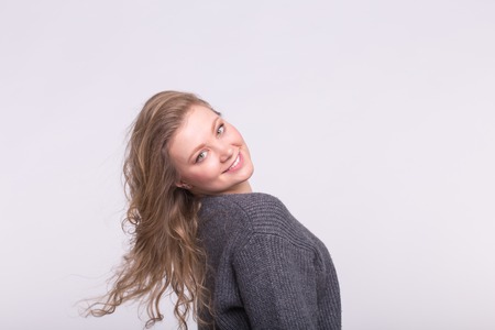 Pretty blonde girl posing over white background with copy spaceの写真素材