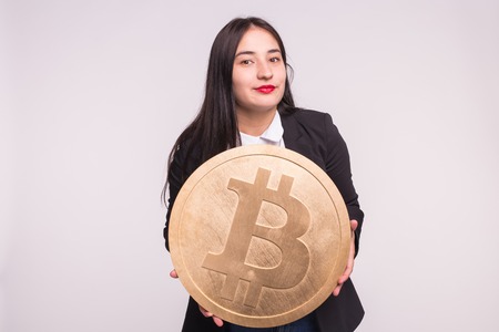 Asian woman holding big bitcoin on white backgroundの写真素材