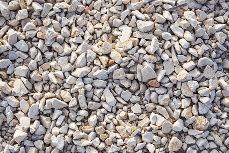Stone background texture on the beach, top view.