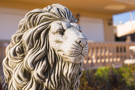 Stone lion statue. Marble Sculpture of a lion on pedestal.の写真素材