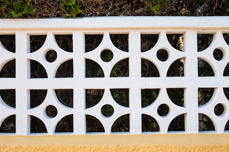 White stone fence. White fence in perspective