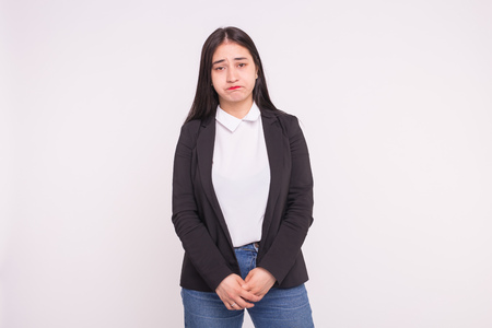 Feelings, emotions and people concept - Sad asian young woman on white background with copy spaceの写真素材