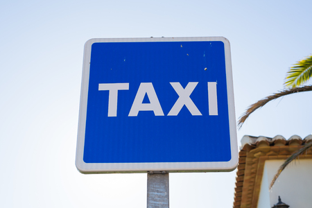 Blue Taxi Sign in the city centreの写真素材