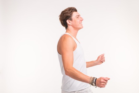 Young handsome dancing man on a white background with copy spaceの写真素材