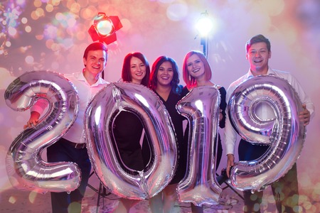 Party, holidays and people concept - Group of friends celebrating New Year holding big 2019 symbol