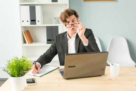 Joke, office and business people concept - man took off the glasses in office, he is bored and...