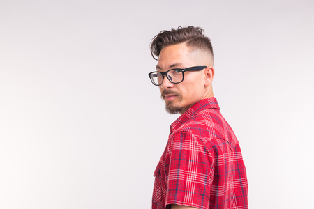 People, beauty and fashion concept - close up portrait young stylish handsome man on white background with copy spaceの写真素材