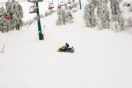 January 1, 2017, Cyprus, Troodos mountains. Ski lifts and cable cars going up the mountain bringing snowboarders to ski slopes.のeditorial素材