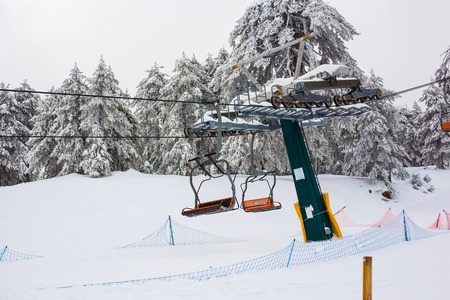 January 1, 2017, Cyprus, Troodos mountains. Ski lifts and cable cars going up the mountain bringing snowboarders to ski slopes.のeditorial素材