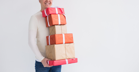 Christmas and holidays concept - Close up of man with many gifts on white background with copy spaceの写真素材
