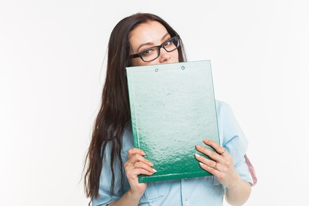 Business and people concept - beautiful young woman holding green paper folder over white background
