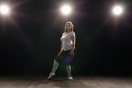 Hip-hop, jazz-funk, tecktonik, waacking, trance and street dances concept - Young woman dancing jazz-funk at studioの写真素材