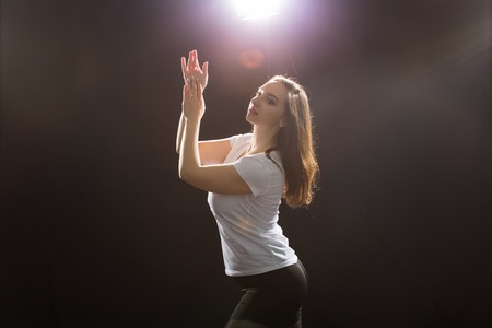 People and dancing concept - Close up of young athletic woman dancing street dance in studio