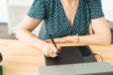 Office, graphic designer concept - Business woman hands holding digital tablet, drawing the sketch