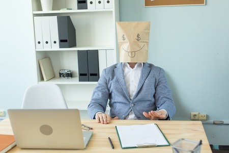 Business, emotions and money concept - office crazy man put a package with painted funny face on her head. Dollar sign in her eyesの写真素材