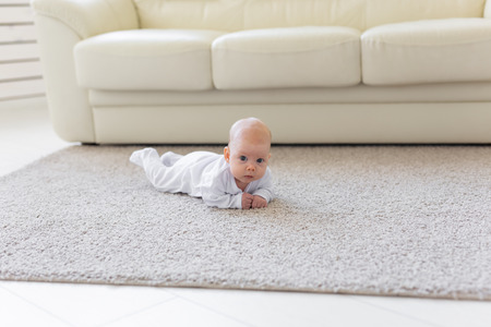 Child, childhood and infant concept - Pretty baby lie on the floorの写真素材