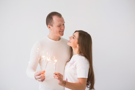 Romantic beautiful couple having date at Valentines Day. Man and woman holding sparklersの写真素材