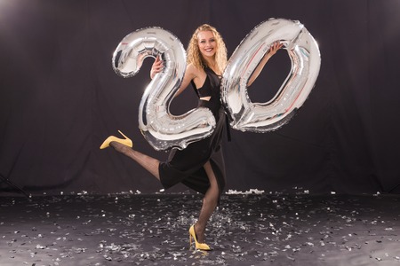 Happy birthday concept - Beautiful young woman with number-shaped 20 balloonsの写真素材