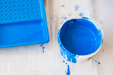 House renovation and redecoration concept - paint bucket on white floor, top view.の写真素材