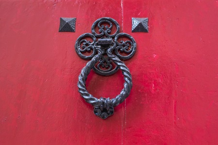 Ancient door knocker on a wooden door.の写真素材