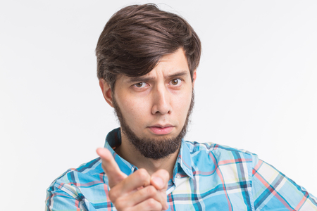 People, gesture and emotions concept - young man waving his finger on white backgroundの写真素材