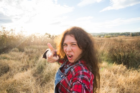 Travel, vacation and holiday concept - Funny young woman taking selfie over beautiful landscapeの写真素材