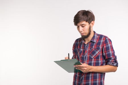 Business and planning concept - Handsome smiling man with clipboard on white background with copy spaceの写真素材