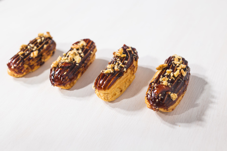 Food, desserts and bakery concept - Traditional French dessert eclairs with chocolate and nuts