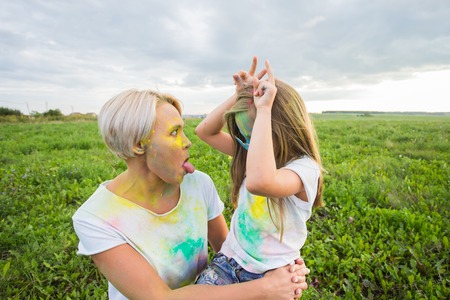 Happiness, Holi festival and holidays concept - two young women and girl having fun on holi festivalの写真素材