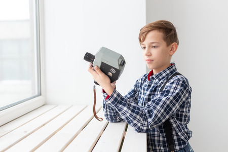 photographer, children and hobby concept - Boy hold an old cameraの写真素材