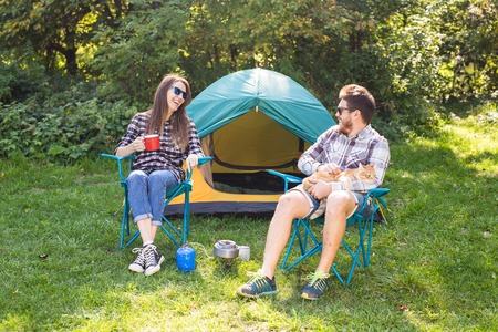 People, tourism and nature concept - Couple having fun on camping tripの写真素材
