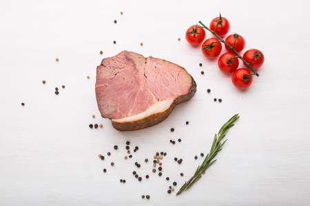 Food, meat and delicious concept - horse meat with pepper and tomatoes, top viewの写真素材