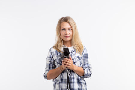 Technologies, photographing and people concept - blonde young woman with retro camera over white background with copy spaceの写真素材