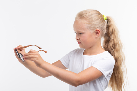 Beautiful child girl with glasses isolated on whiteの写真素材