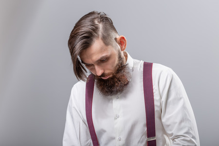 people, fashion and style concept - close-up portrait of young hipster on grey backgroundの写真素材