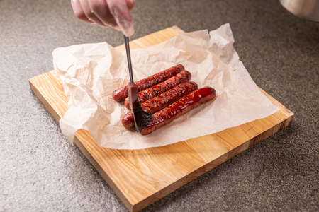 Food concept - Traditional horse meat sausage covered with sauceの写真素材