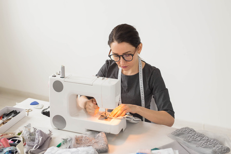 People, tailor and fashion concept - Close up portrait of working place fashion designer with sewing...