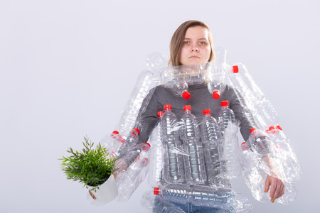 Environmental Protection, people and recyclable plastic concept - exhausted woman concerned with...
