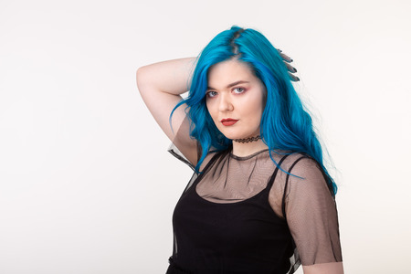 People and fashion concept - Beautiful woman with blue hair posing over white backgroundの写真素材