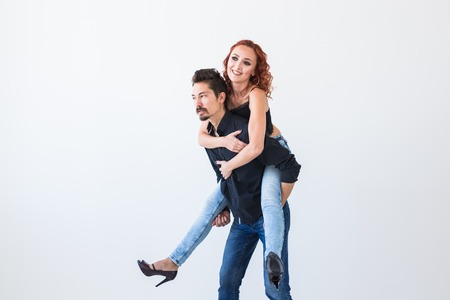 Friendship, people concept - young woman jumped on the mans back
