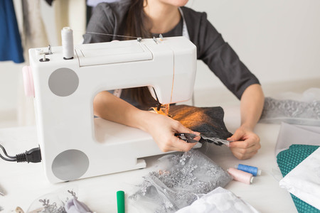people, dressmaker, tailor and fashion concept - close up of young fashion designer in her showroomの写真素材
