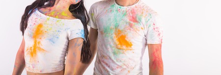 Holiday, holi and people concept - Happy couple having fun covered in paint on white backgroundの写真素材