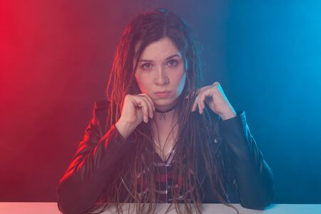 Portrait of young woman with dreadlocks over the dark backgroundの写真素材