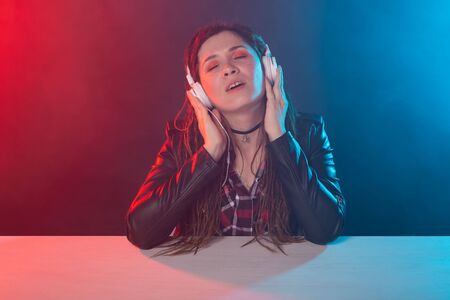 Meloman, music and people concept - young woman with dreadlocks listen to the music and enjoy itの写真素材