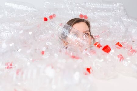 Environmental Protection, people and recyclable plastic concept - exhausted woman concerned with...